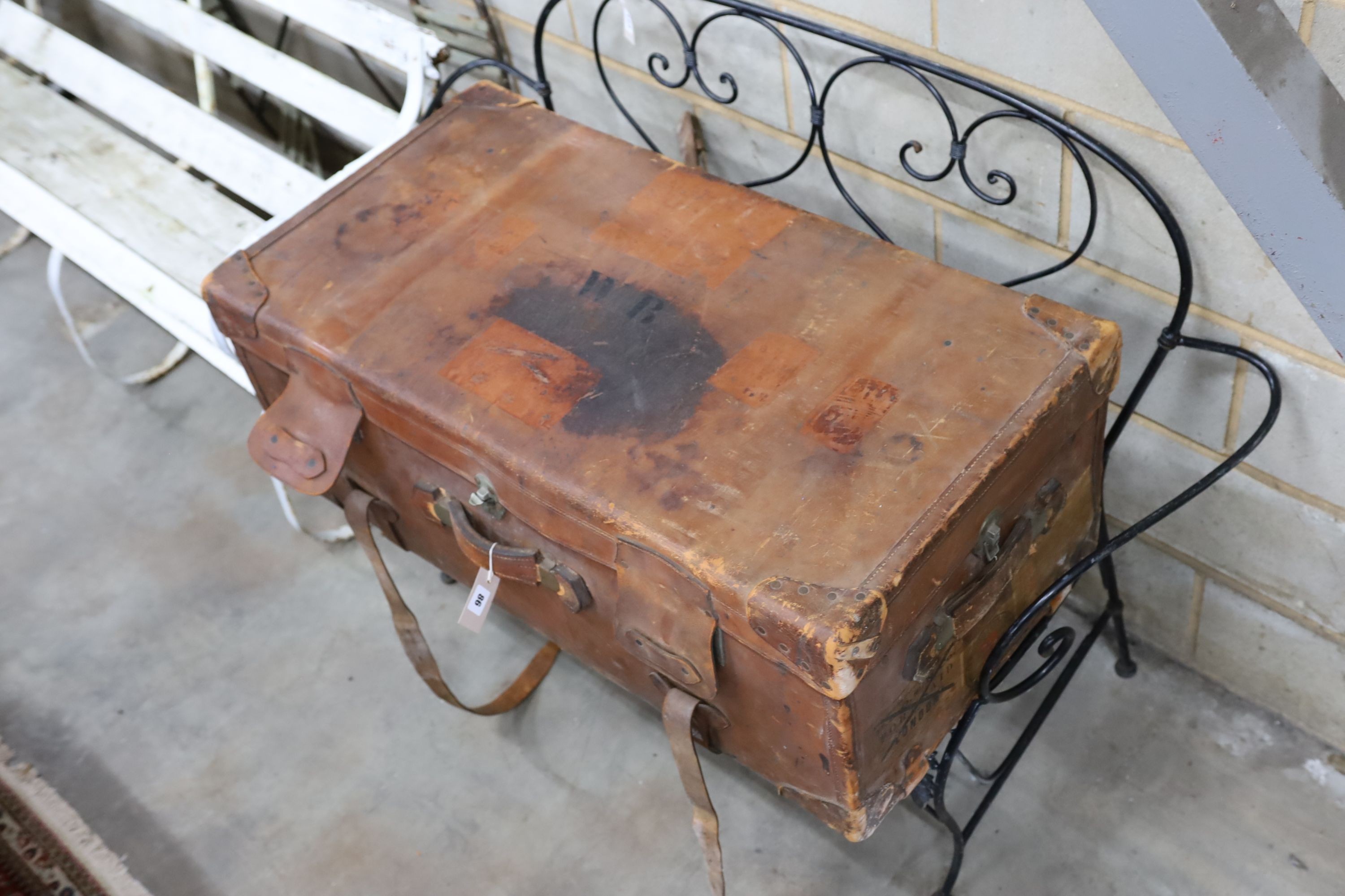 An early 20th century large tan leather trunk with labels, length 100cm, depth 53cm, height 39cm